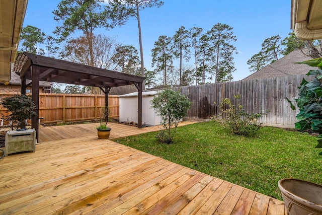 deck featuring a yard, a pergola, and a fenced backyard