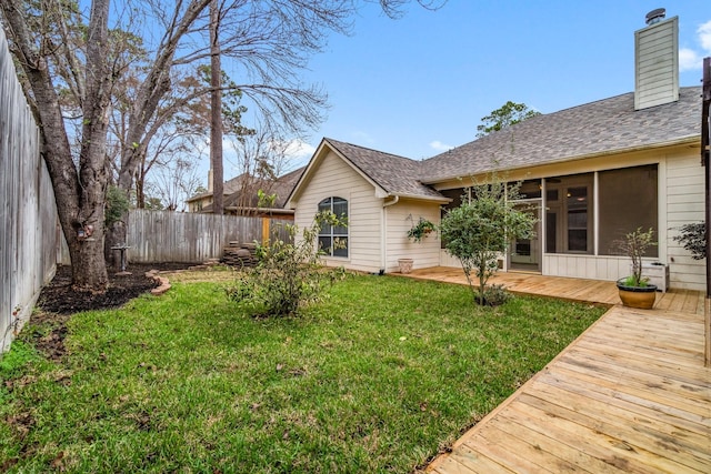 view of yard with a wooden deck and fence