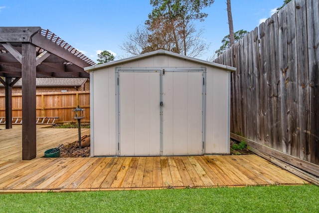 view of shed with a pergola and fence