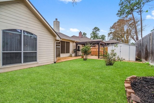 view of yard featuring an outbuilding, a storage unit, a fenced backyard, and a patio