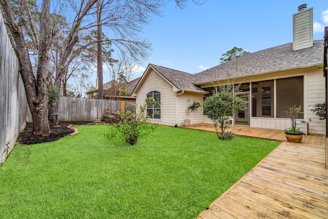 view of yard with a deck and fence