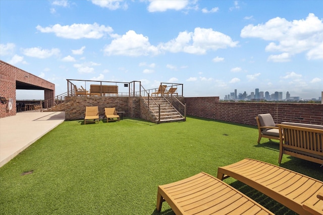 view of yard with a patio area and stairway