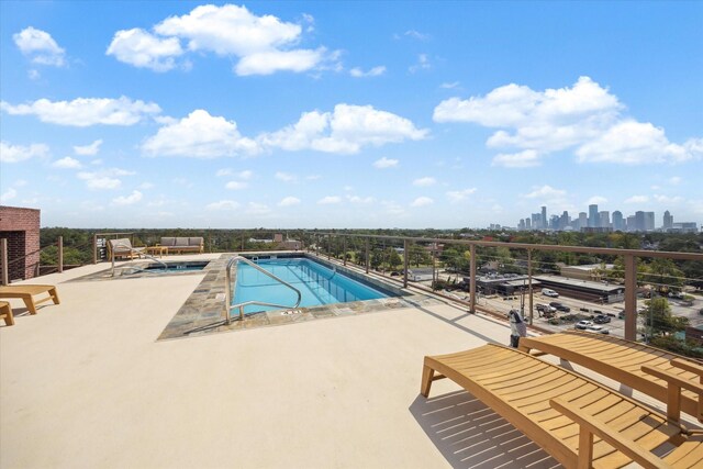 community pool featuring a city view and a patio
