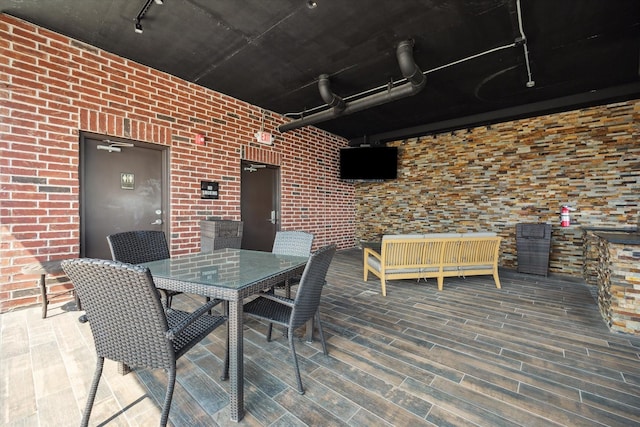 wooden deck featuring outdoor dining area and an outdoor hangout area