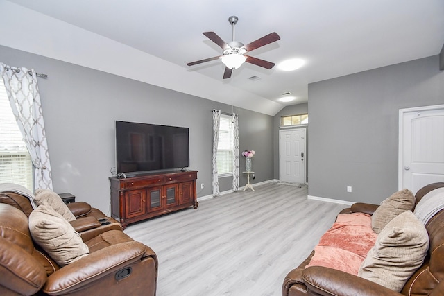 living room featuring visible vents, ceiling fan, baseboards, vaulted ceiling, and light wood-style flooring