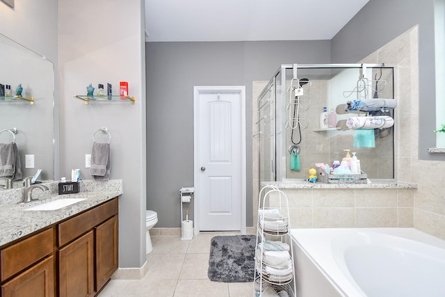 full bath with tile patterned floors, toilet, a shower stall, a bath, and vanity