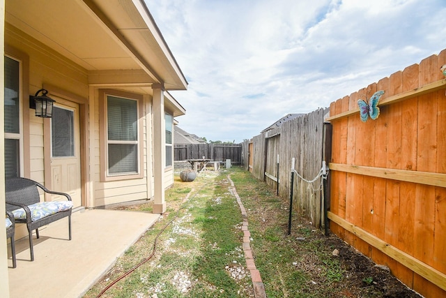 view of yard featuring a patio area and a fenced backyard