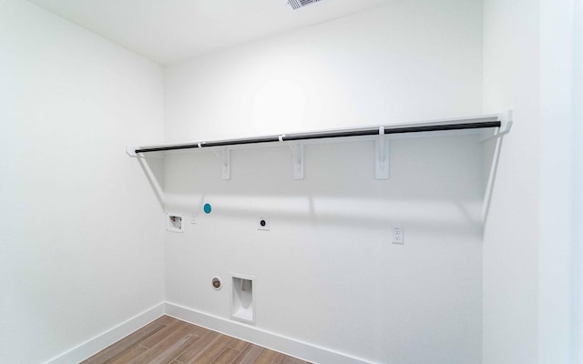 409 Twin Lakes Blvd, West Columbia, TX 77486 - laundry room with hookup for a gas dryer, electric dryer hookup, washer hookup, wood finished floors, and baseboards