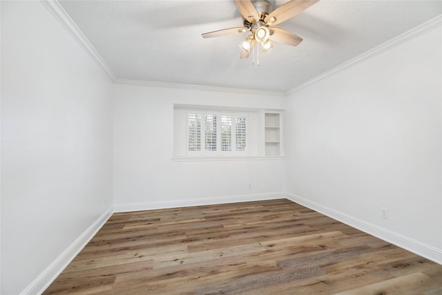 unfurnished room featuring crown molding, baseboards, ceiling fan, wood finished floors, and a textured ceiling