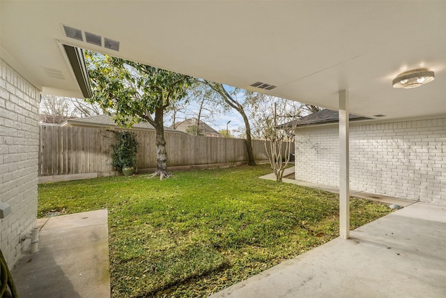 view of yard featuring visible vents and a fenced backyard