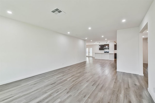 unfurnished living room with baseboards, recessed lighting, visible vents, and light wood-type flooring