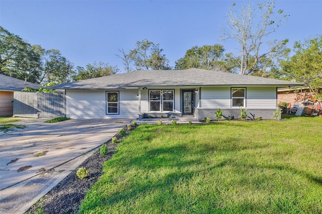 ranch-style home featuring brick siding, a front yard, and fence