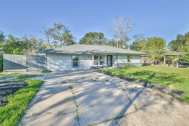 ranch-style house with brick siding, a front yard, and fence