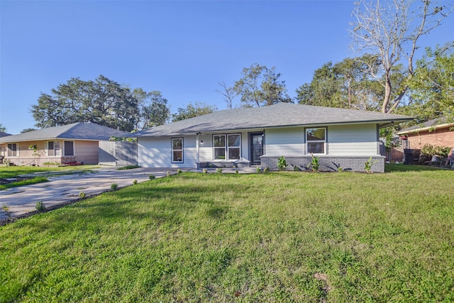 ranch-style house with brick siding, a front lawn, and fence