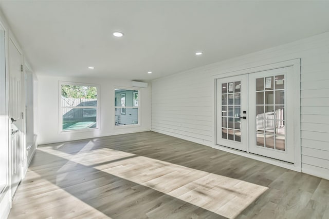 interior space featuring french doors and a wall unit AC