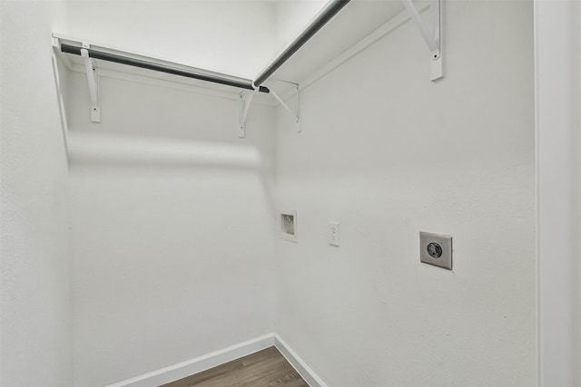 laundry area with dark wood-type flooring, baseboards, laundry area, hookup for a washing machine, and electric dryer hookup