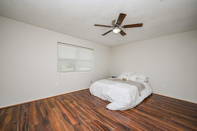 unfurnished bedroom with baseboards, a textured ceiling, ceiling fan, and wood finished floors