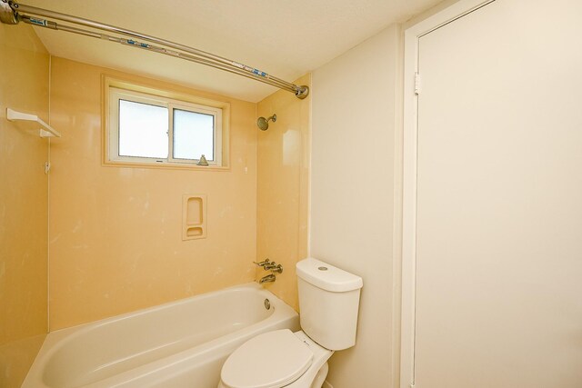 bathroom featuring toilet and shower / tub combination