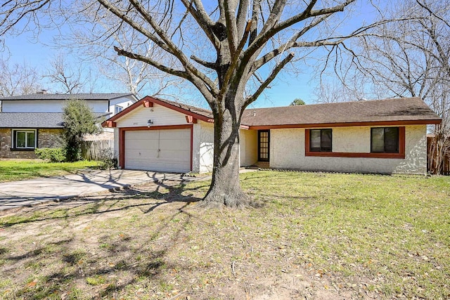 view of front of property with fence, an attached garage, stucco siding, a front lawn, and concrete driveway