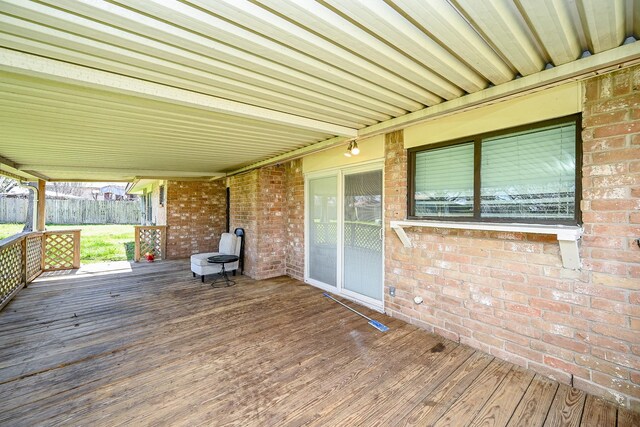 wooden terrace featuring fence