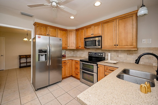 kitchen with a sink, stainless steel appliances, visible vents, and light tile patterned flooring