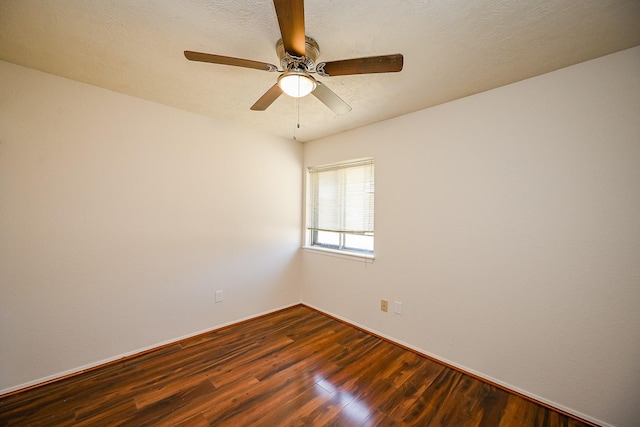 spare room featuring ceiling fan, a textured ceiling, and dark wood finished floors