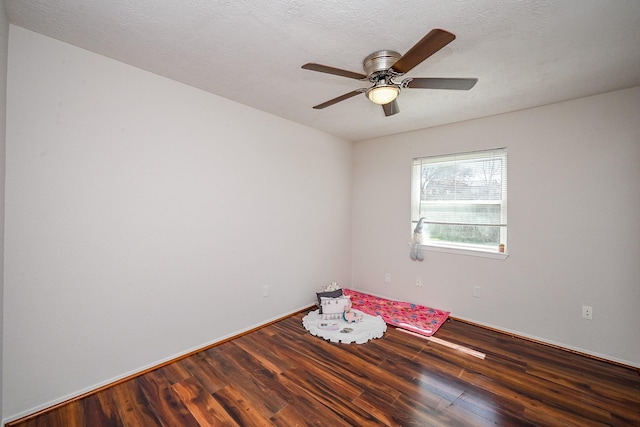 unfurnished room featuring ceiling fan, wood finished floors, and a textured ceiling