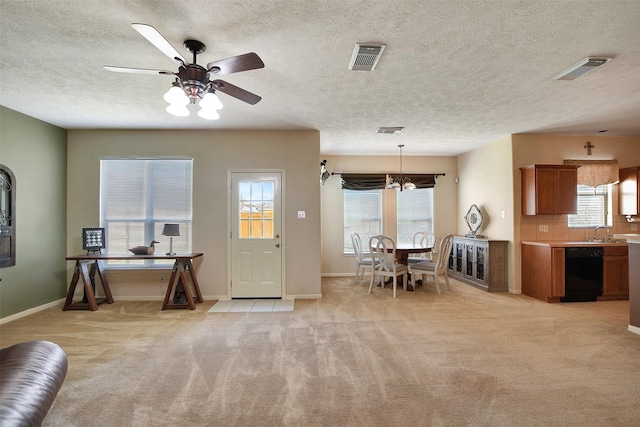 entryway featuring a wealth of natural light, visible vents, and light colored carpet