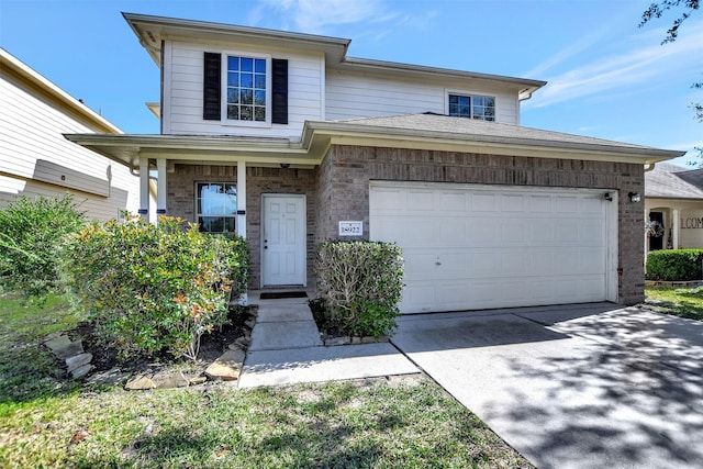 view of front of house with a garage, brick siding, and driveway