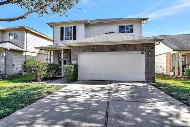 view of front of house featuring a front yard, brick siding, concrete driveway, and an attached garage