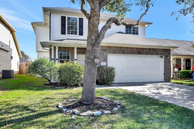 traditional-style house with a front yard, cooling unit, fence, driveway, and a garage