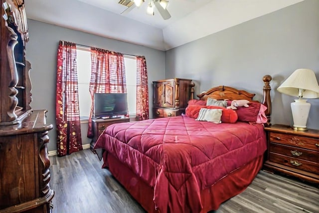 bedroom featuring baseboards, wood finished floors, a ceiling fan, and vaulted ceiling