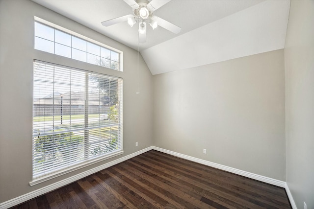 unfurnished room with vaulted ceiling, dark wood-style floors, baseboards, and ceiling fan