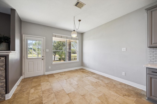 unfurnished dining area featuring visible vents and baseboards