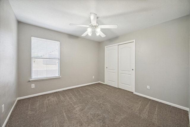 unfurnished bedroom featuring a closet, carpet flooring, a ceiling fan, and baseboards