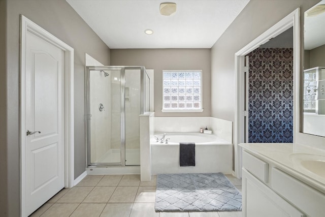 bathroom with vanity, a garden tub, a shower stall, and tile patterned flooring