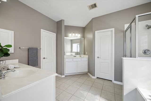 full bathroom featuring tile patterned floors, visible vents, two vanities, a sink, and a shower stall