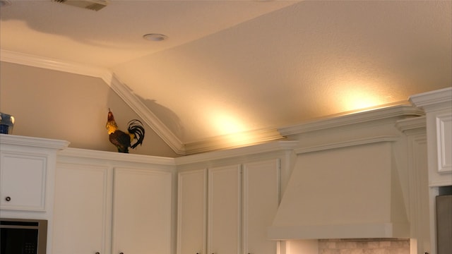 interior details with custom exhaust hood, visible vents, and ornamental molding