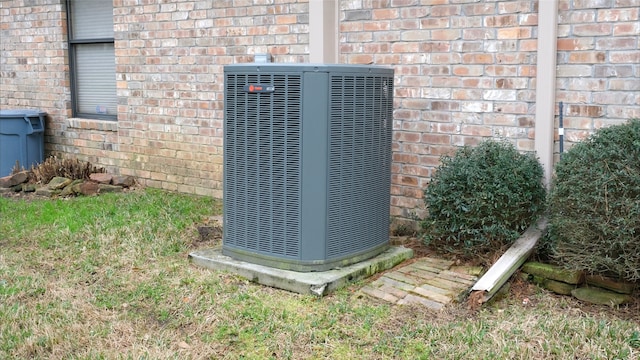 exterior details featuring brick siding and central AC unit