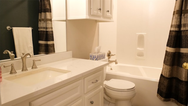 bathroom with toilet, vanity, and shower / tub combo