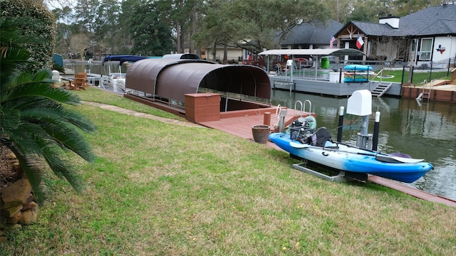 dock area with a yard and a water view