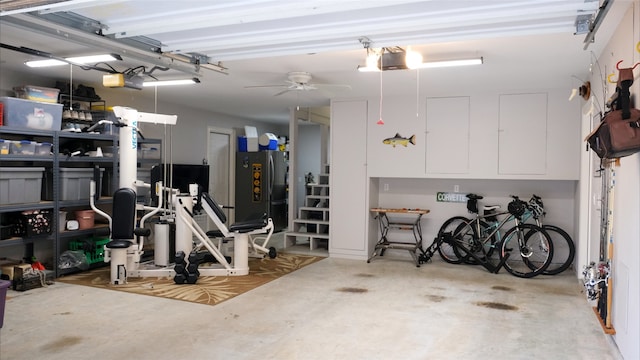 garage featuring a garage door opener, a ceiling fan, and freestanding refrigerator