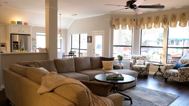 living room with dark wood-type flooring, ornamental molding, lofted ceiling, ceiling fan, and ornate columns