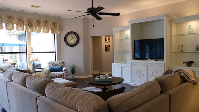 living room with visible vents, ceiling fan, baseboards, dark wood finished floors, and built in features