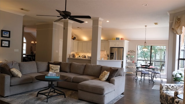 living room featuring dark wood-style floors, visible vents, recessed lighting, ornamental molding, and ceiling fan with notable chandelier