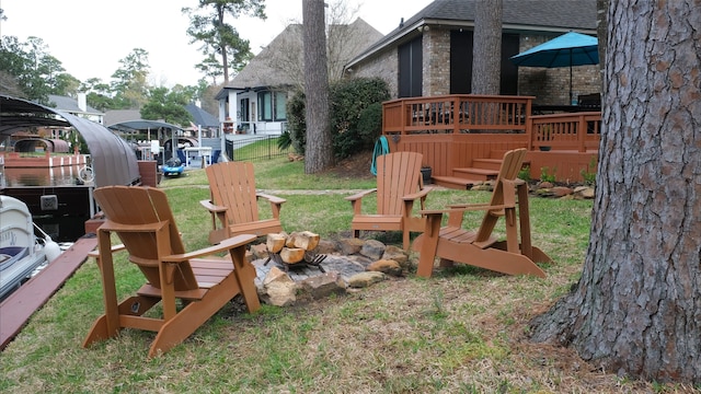 view of yard with a wooden deck and an outdoor fire pit