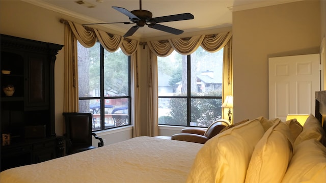 bedroom with crown molding and a ceiling fan