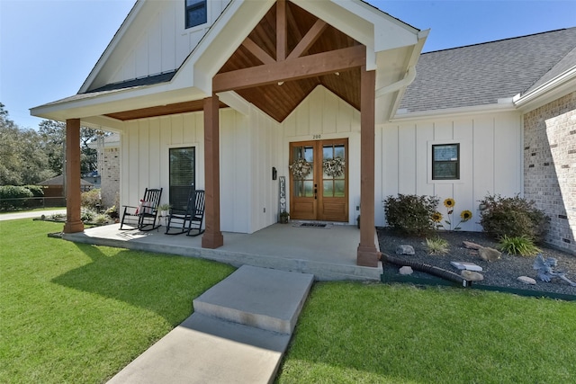 entrance to property with a lawn, board and batten siding, brick siding, and a shingled roof