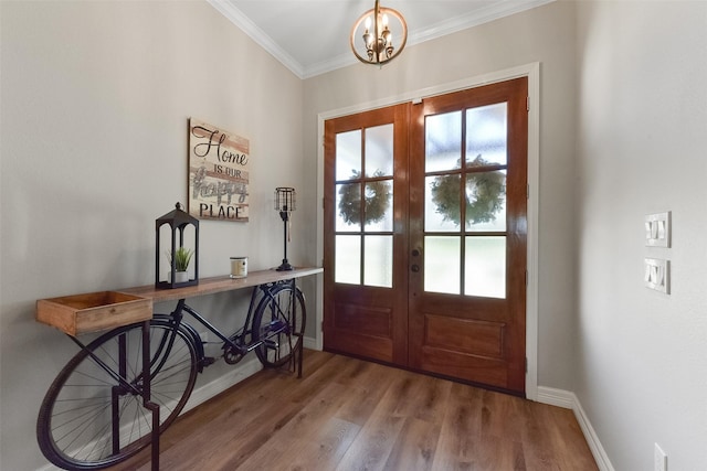 entryway featuring french doors, baseboards, wood finished floors, and crown molding