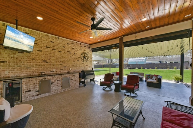 view of patio featuring an outdoor living space, grilling area, ceiling fan, and fence